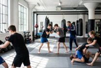 Jovens atletas em treino de artes marciais mistas numa academia desportiva
